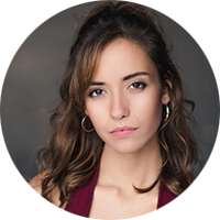 Carmen Lorenzo has long, dark brown hair and is wearing gold hoop earrings